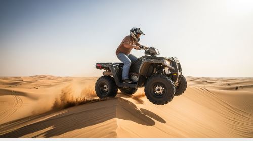 Rider on a Polaris Sportsman quad bike kicking up sand in the Dubai desert with city skyline in the background - Polaris Sportsman Quad Bike Rental in Dubai